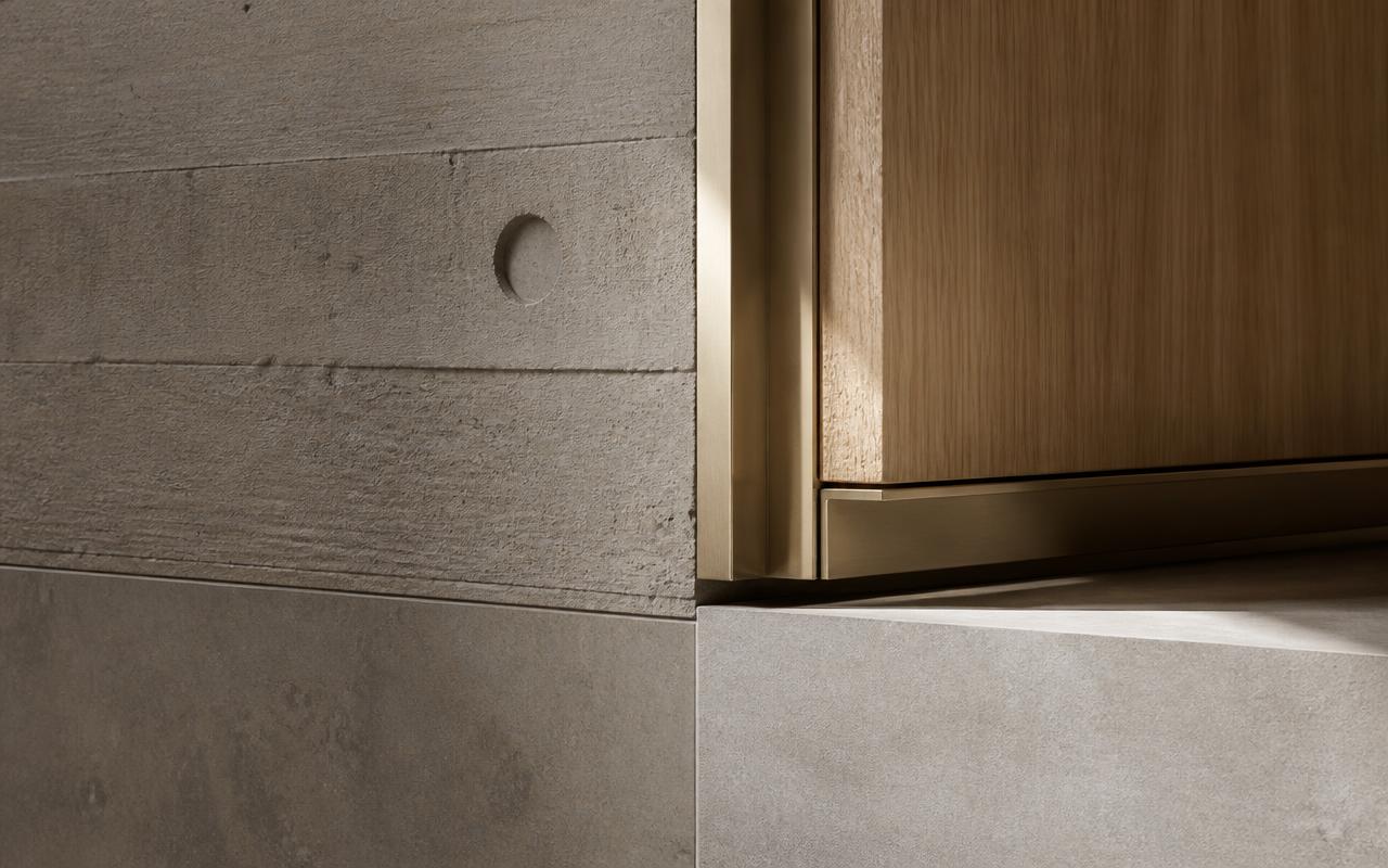 Detail of board-formed concrete, bronze reveal and oak timber junction